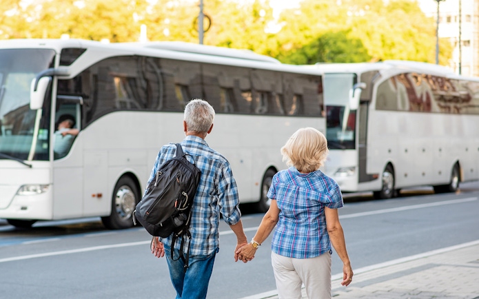 Tourists boarding a bus for Transporte a Puy du Fou Parque from Toledo.