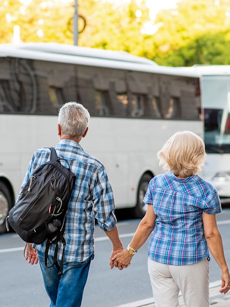Tourists boarding a bus for Transporte a Puy du Fou Parque from Toledo.