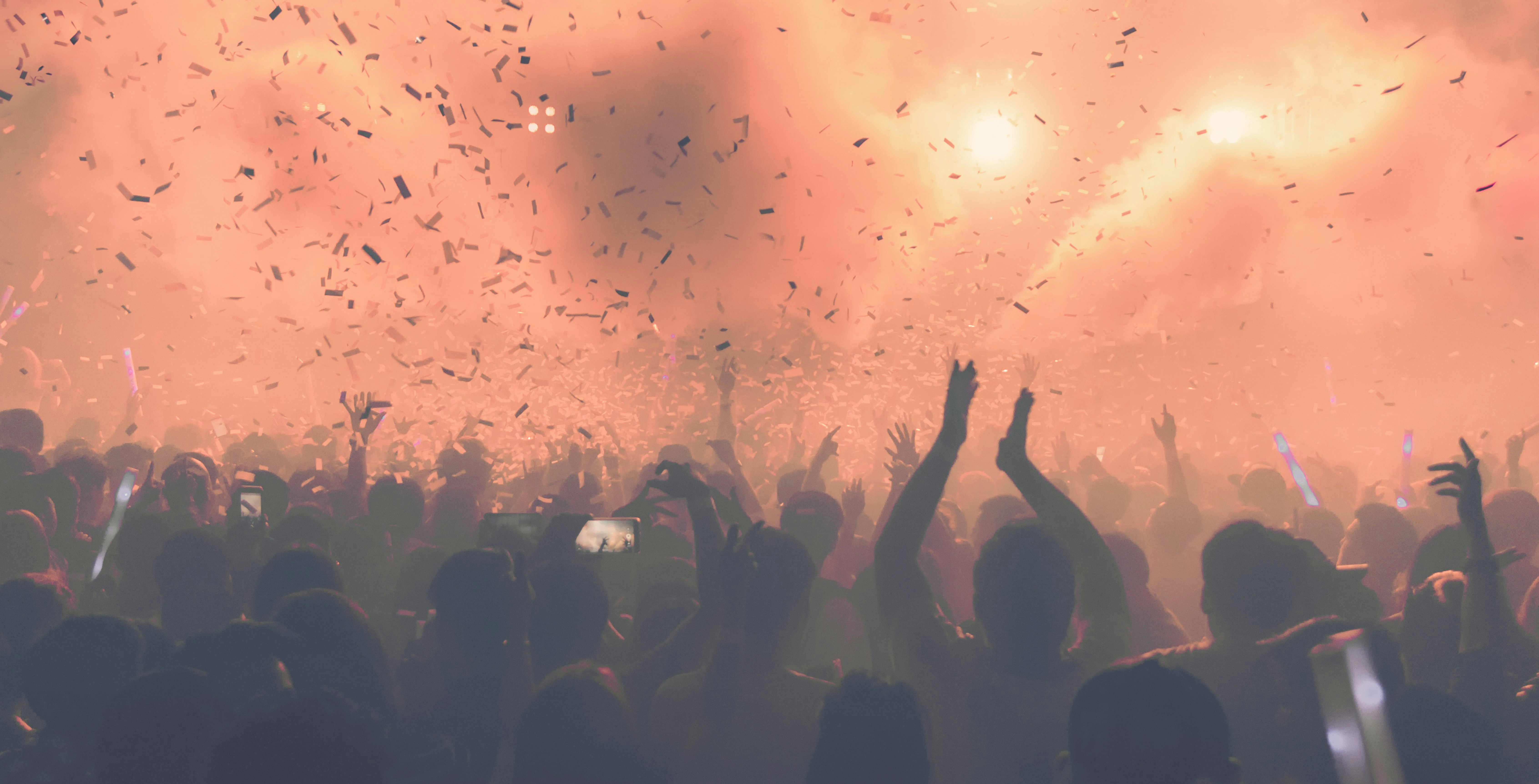 Crowd enjoying a vibrant night event with confetti at 528 Ibiza.