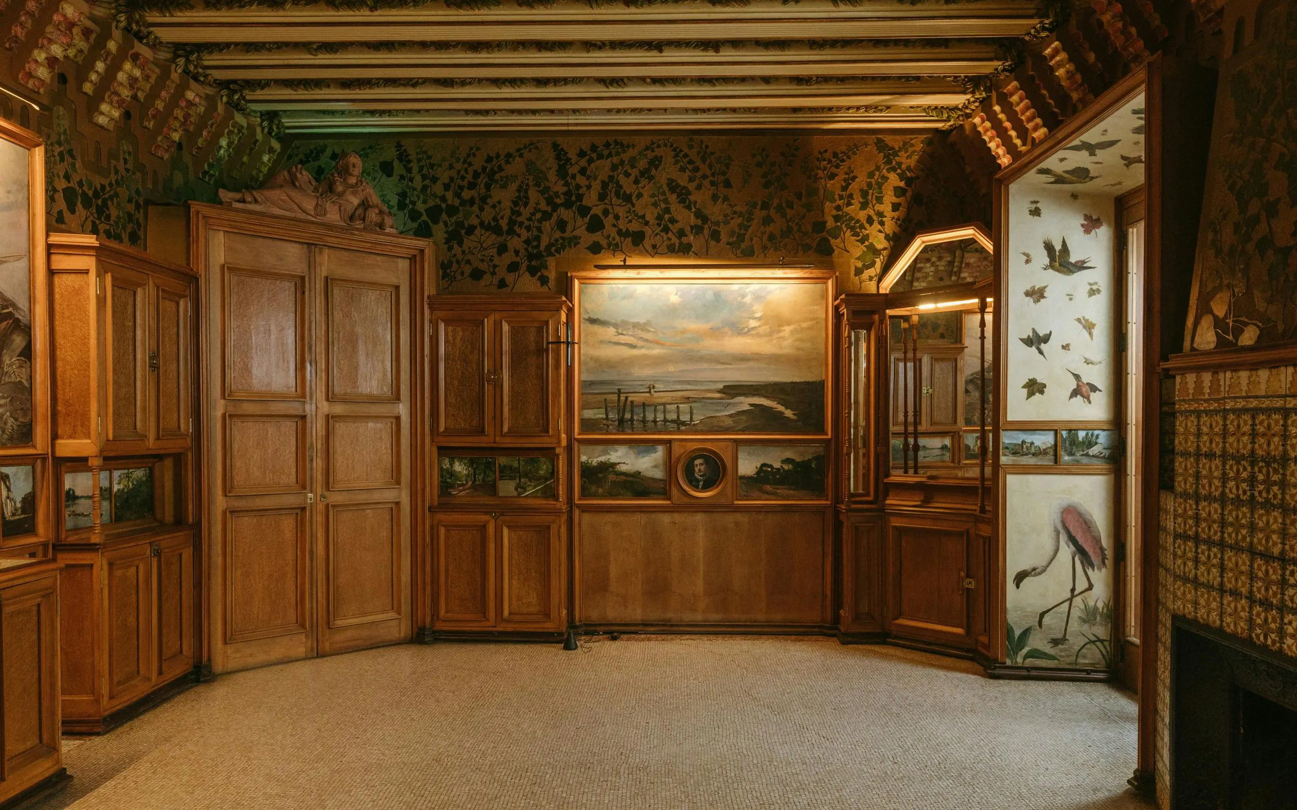 Casa Vicens main floor with ornate wooden cabinets and nature-themed murals.