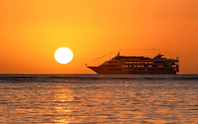 Cruise ship sailing at sunset during Star Independence Day Cruise, Hawaii.