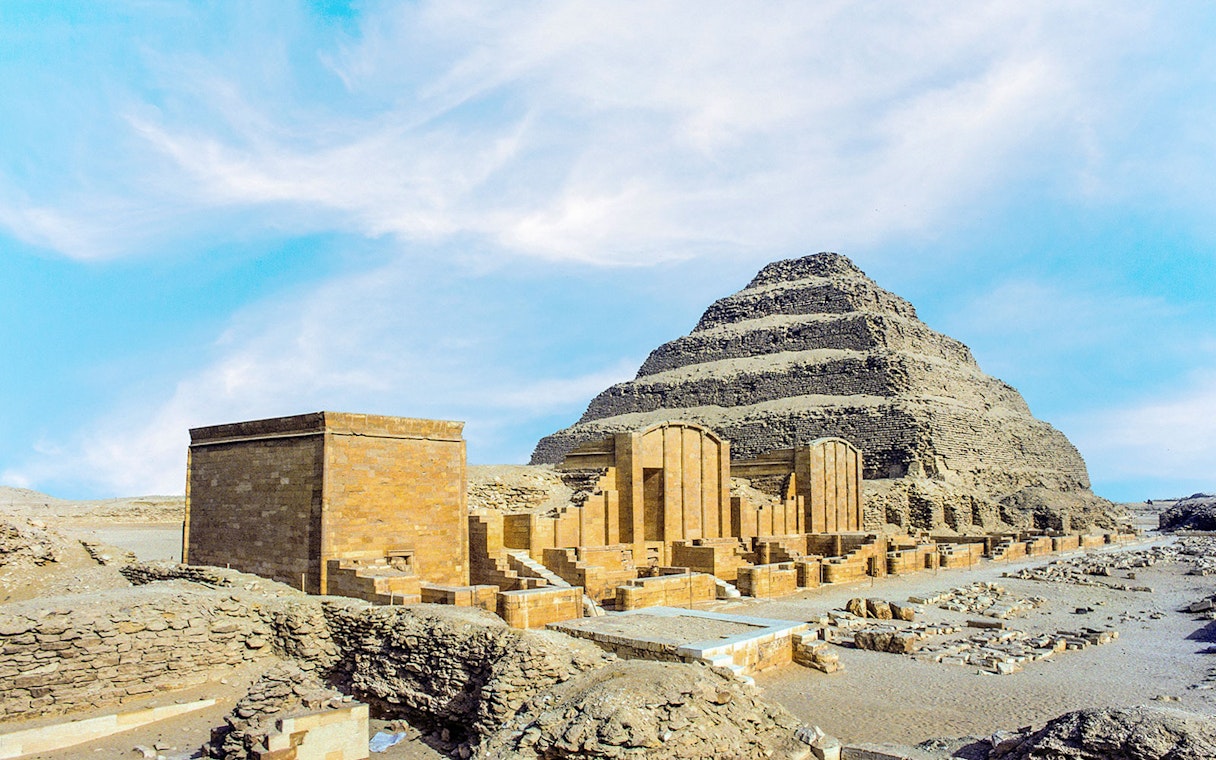 Pyramid of Djoser at Saqqara necropolis, Egypt, with surrounding ancient structures.