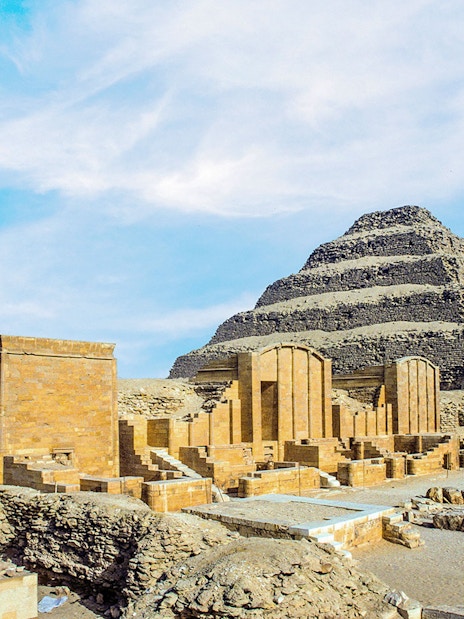 Pyramid of Djoser at Saqqara necropolis, Egypt, with surrounding ancient structures.