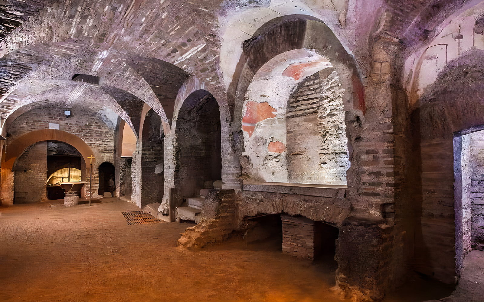Roman Catacombs with ancient arches and altar, part of Capuchin Crypts tour.