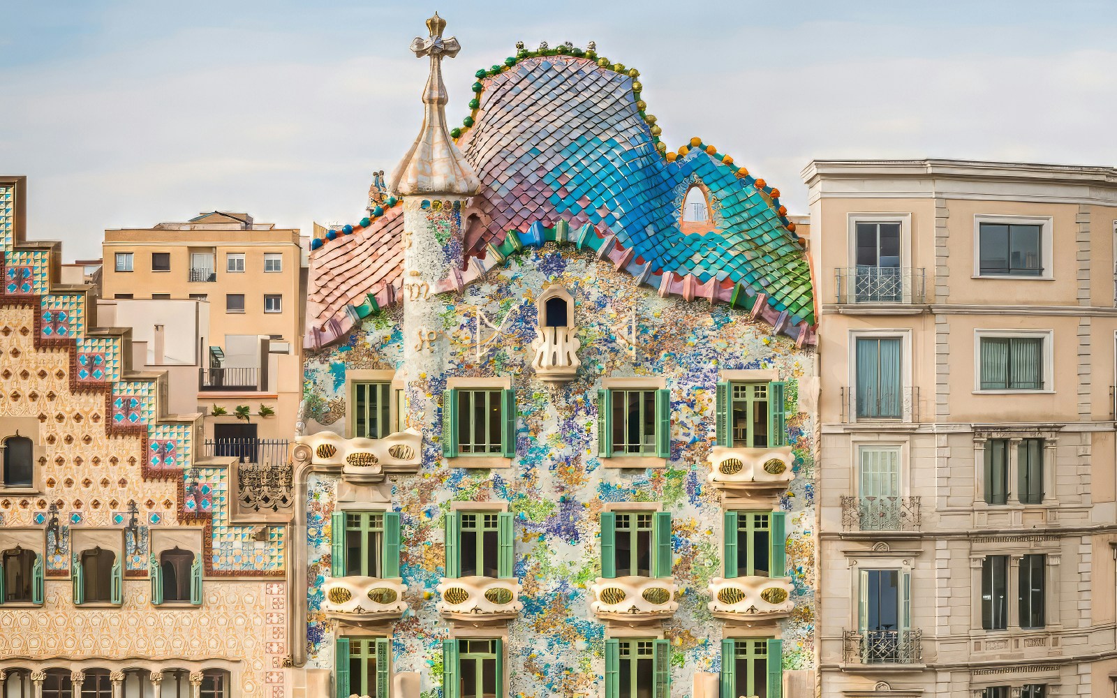 Facade of Casa Batlló with colorful mosaic tiles in Barcelona.
