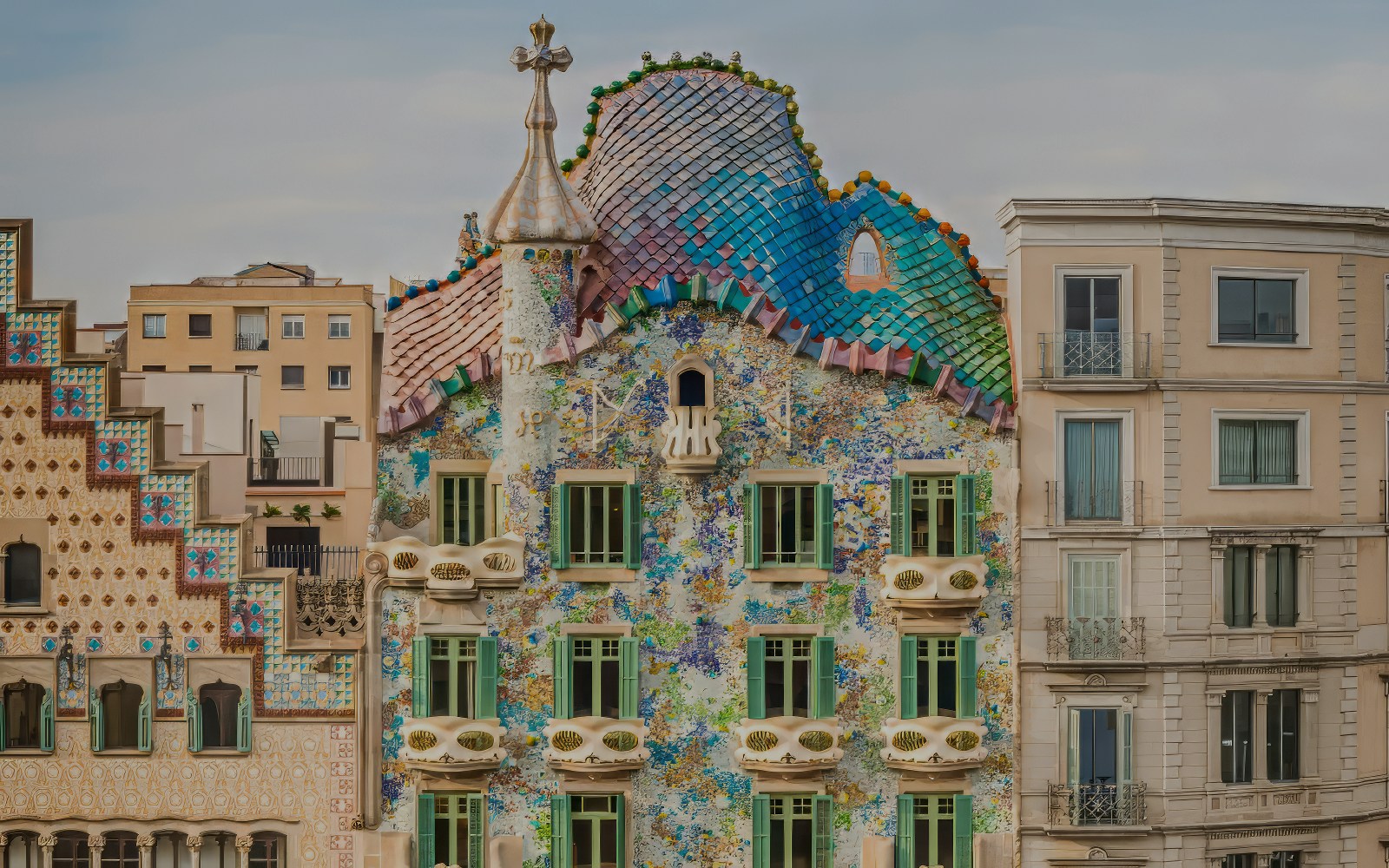 Facade of Casa Batlló with colorful mosaic tiles in Barcelona.