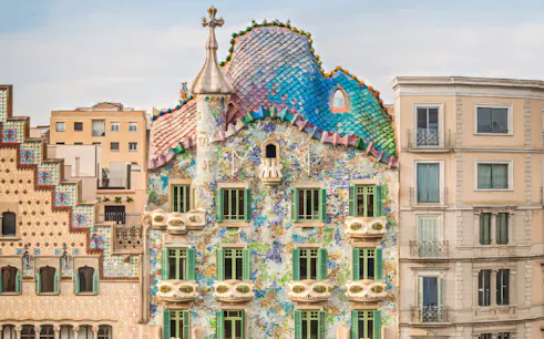 Facade of Casa Batlló with colorful mosaic tiles in Barcelona.