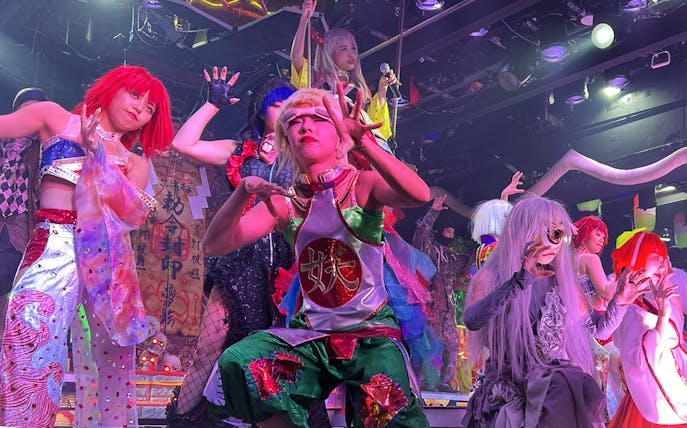 Performers in vibrant costumes at Samurai Restaurant show in Tokyo.