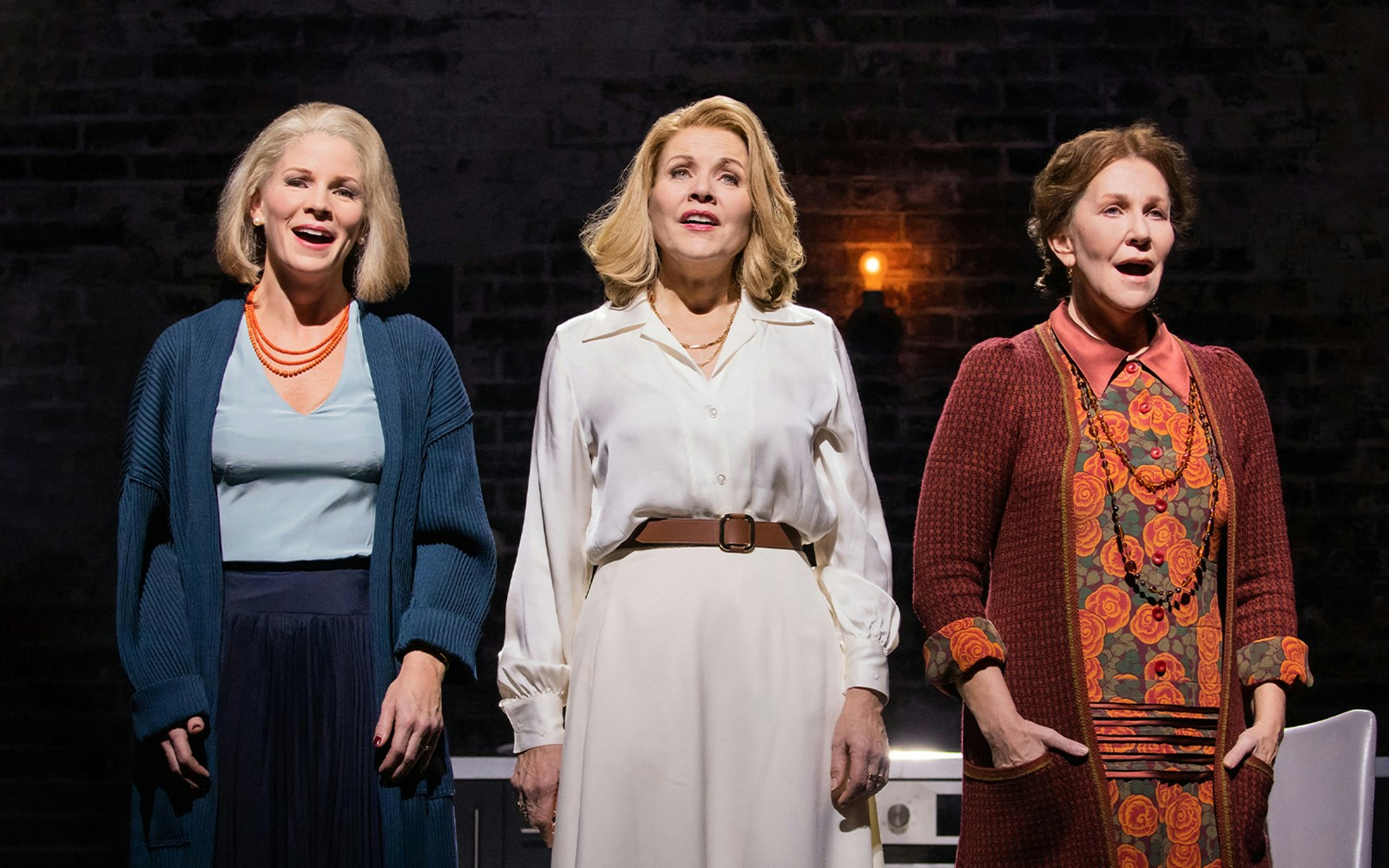 Three performers on stage during a scene from "The Hours" musical.