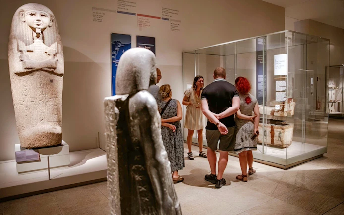 Visitors exploring ancient artifacts at the Egyptian Museum in Turin.