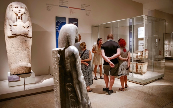 Visitors exploring ancient artifacts at the Egyptian Museum in Turin.