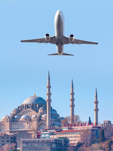 Airplane flying over Suleymaniye Mosque in Istanbul, Turkey.