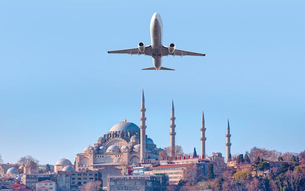 Airplane flying over Suleymaniye Mosque in Istanbul, Turkey.