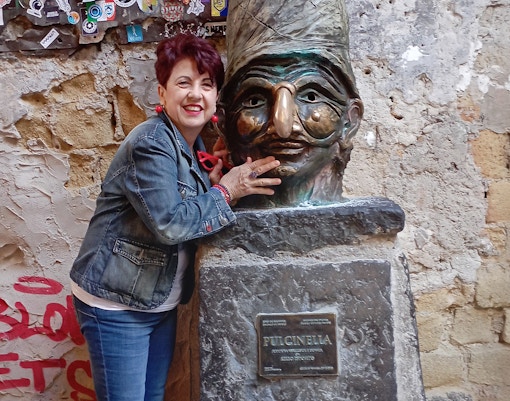 Pulcinella statue at Naples Underground entrance, Piazza San Gaetano tour.