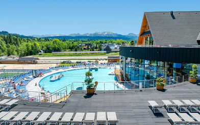 Chocholowskie Thermal Baths exterior with pool and mountain view in Zakopane.