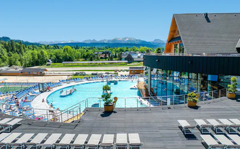 Chocholowskie Thermal Baths exterior with pool and mountain view in Zakopane.