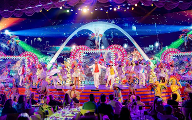 Performers in vibrant costumes on stage at Roxy Dinner Show, Rio de Janeiro.
