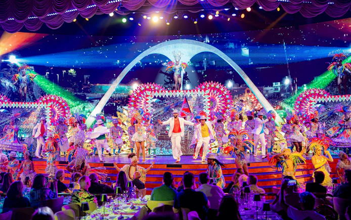 Performers in vibrant costumes on stage at Roxy Dinner Show, Rio de Janeiro.