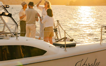 Guests enjoying a Sydney Harbour cruise at sunset.