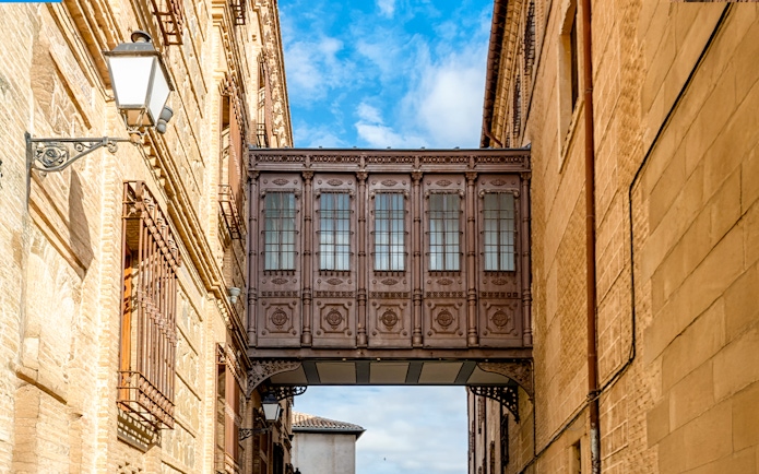 Cobertizo de las Doncellas bridge connecting historic buildings in Toledo, Spain.