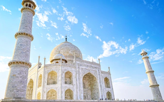 Taj Mahal with minarets under blue sky, Agra, India.