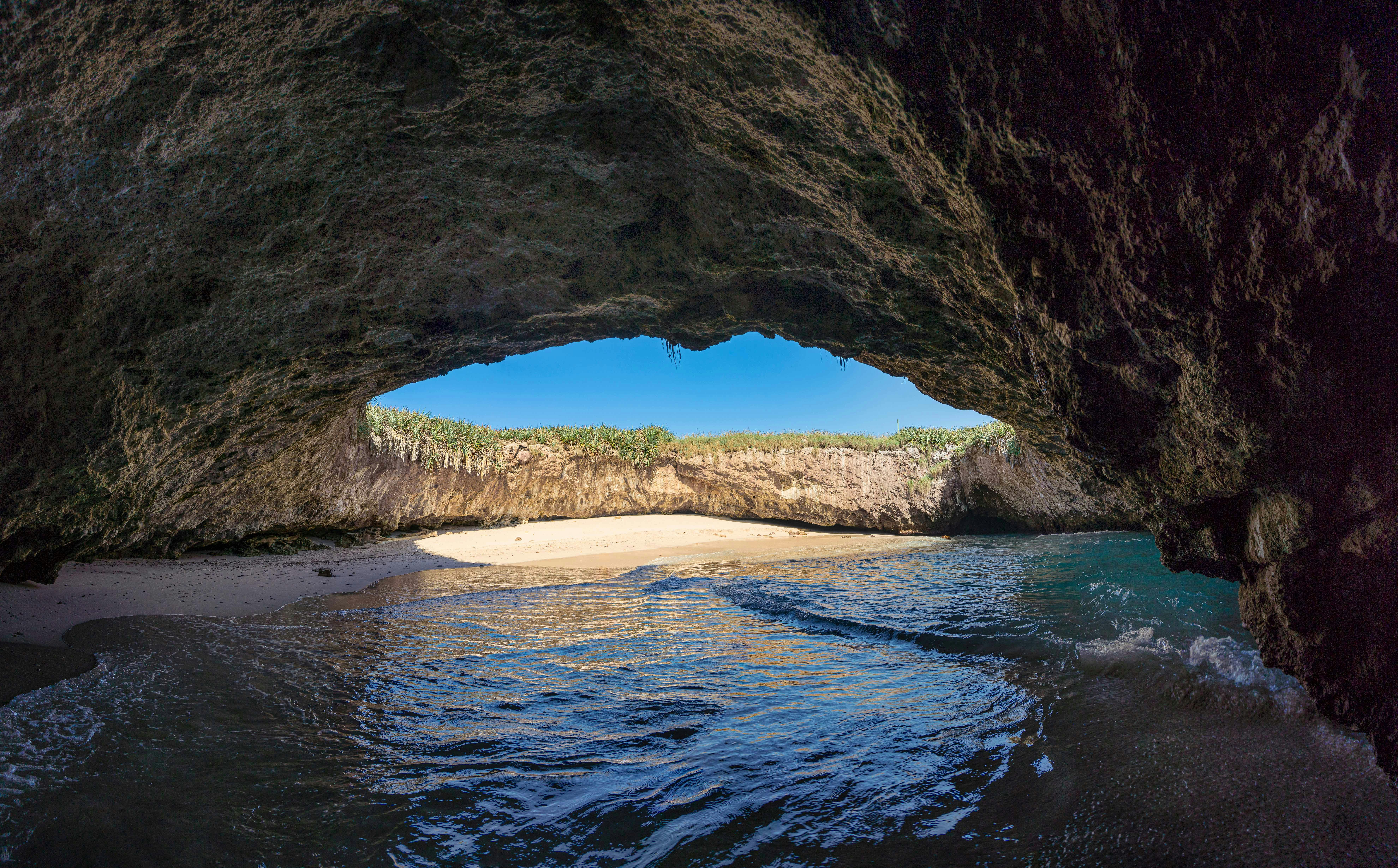 Kayakers exploring hidden sea caves along the Algarve coast in Portugal.