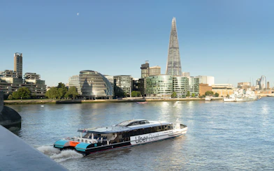 Uber Boat by Thames Clippers on the River Thames with London skyline.