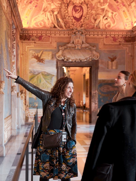 Guide leading tour group through Gallery of Maps, Vatican Museum.