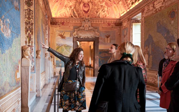 Guide leading tour group through Gallery of Maps, Vatican Museum.