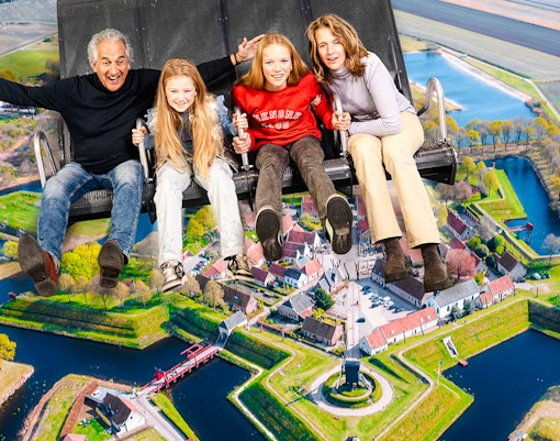 Tourists on 5D ride at This Is Holland, Amsterdam, viewing Dutch landscape.