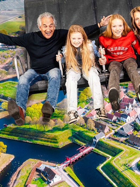 Tourists on 5D ride at This Is Holland, Amsterdam, viewing Dutch landscape.