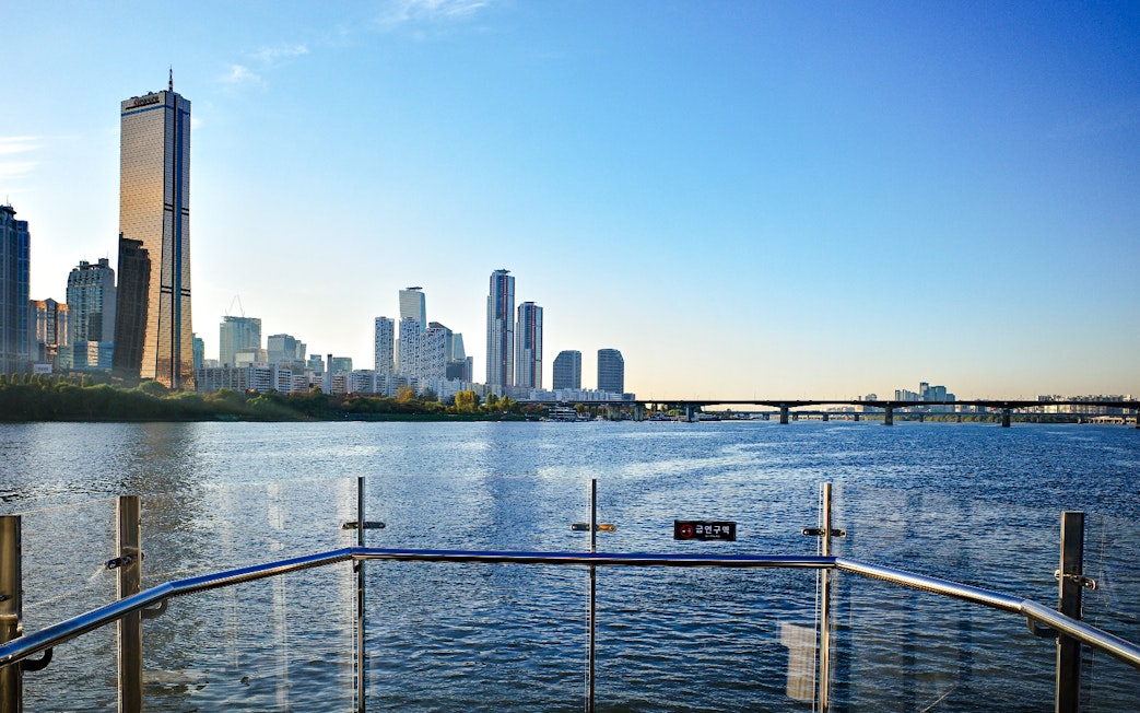 Hangang River view from Eland Cruise with Seoul skyline and bridge in the background.