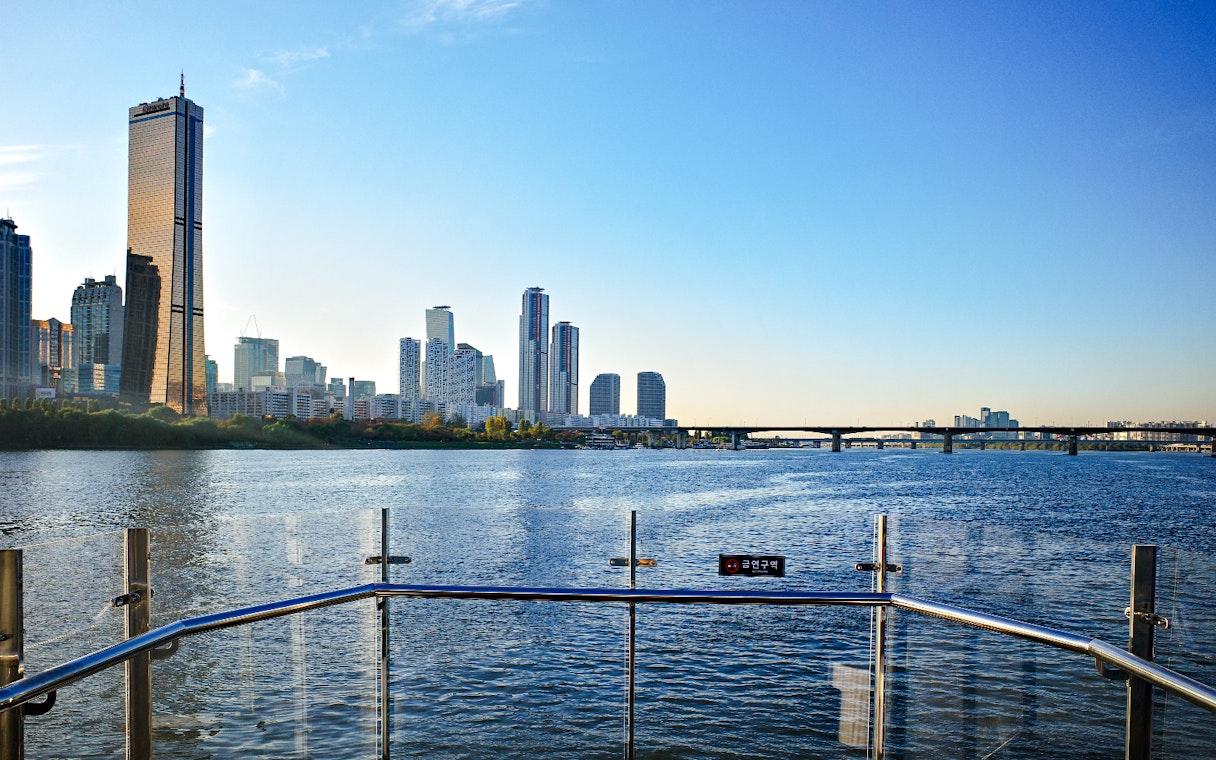 Hangang River view from Eland Cruise with Seoul skyline and bridge in the background.