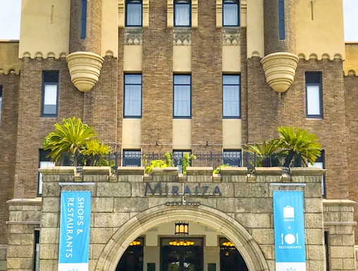 Entrance of Mirai Museum, featuring banners for shops and restaurants, related to the Illusion Museum and Magic Show.