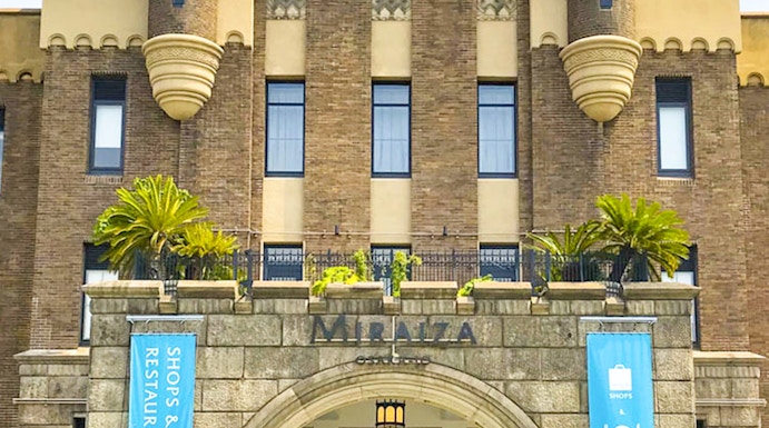 Entrance of Mirai Museum, featuring banners for shops and restaurants, related to the Illusion Museum and Magic Show.