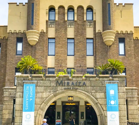 Entrance of Mirai Museum, featuring banners for shops and restaurants, related to the Illusion Museum and Magic Show.
