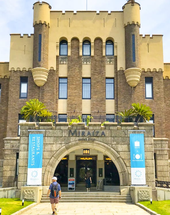 Entrance of Mirai Museum, featuring banners for shops and restaurants, related to the Illusion Museum and Magic Show.