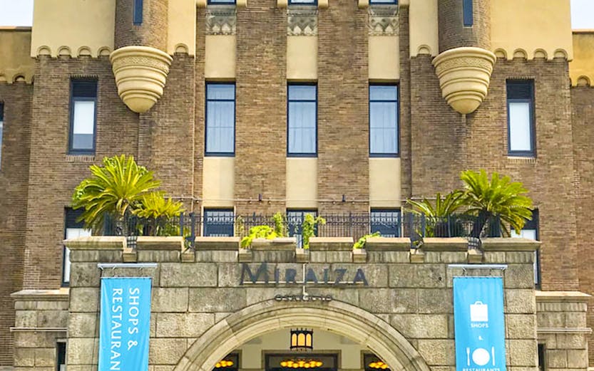 Entrance of Mirai Museum, featuring banners for shops and restaurants, related to the Illusion Museum and Magic Show.