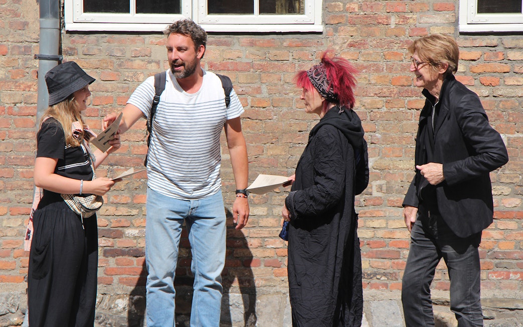 Participants discussing clues during a murder mystery at Christiansborg Palace.