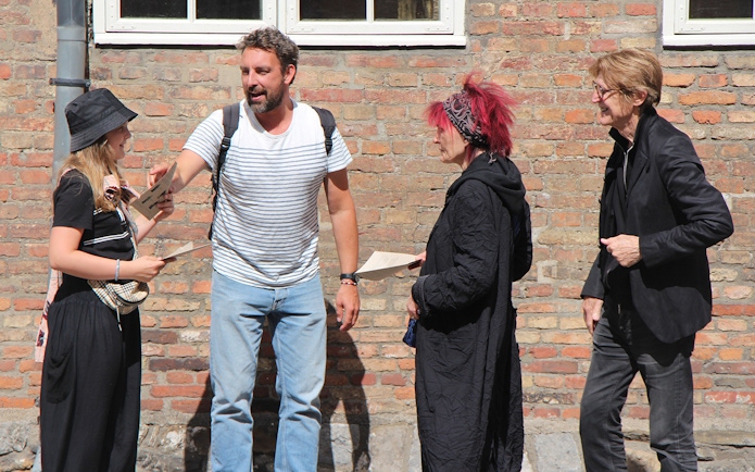 Participants discussing clues during a murder mystery at Christiansborg Palace.