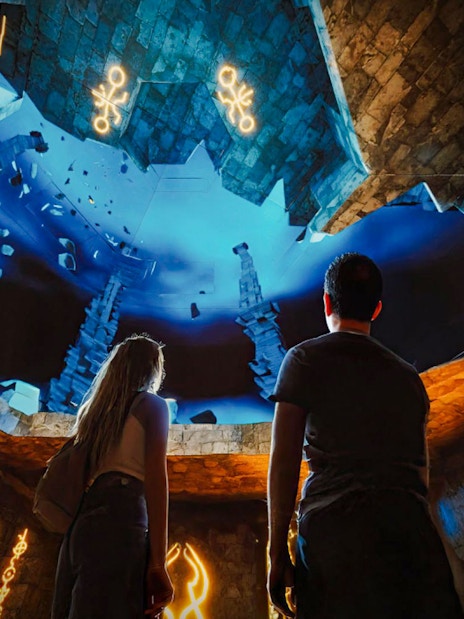 Visitors exploring immersive underwater scene at The Lost World Aquarium.