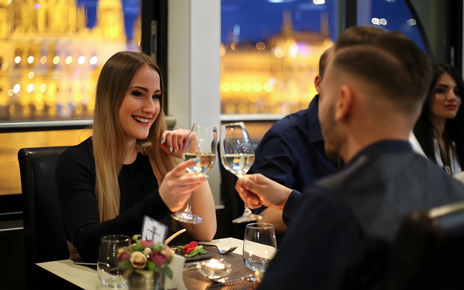 Couple toasting champagne on Danube River cruise in Budapest.
