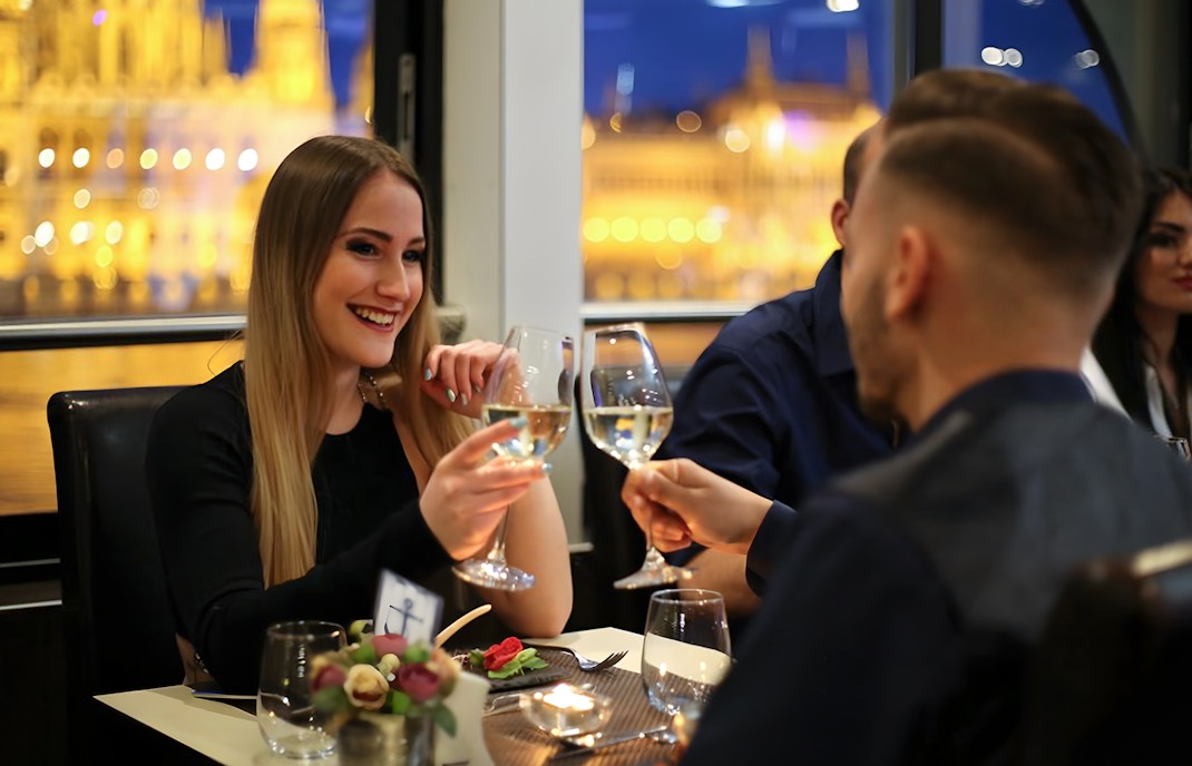 Couple toasting champagne on Danube River cruise in Budapest.