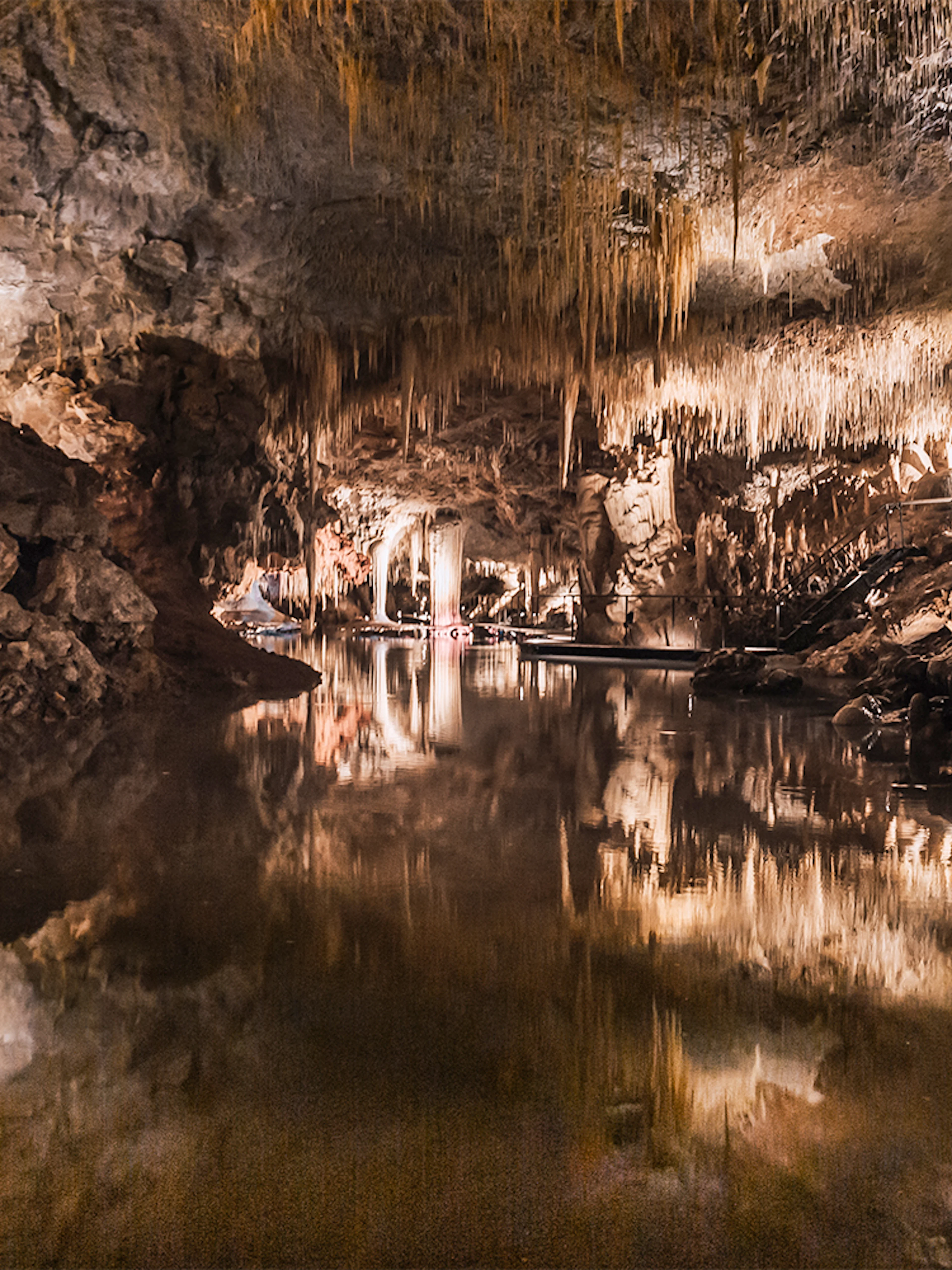 Stalactites reflected in still water inside Lake Cave, Margaret River.