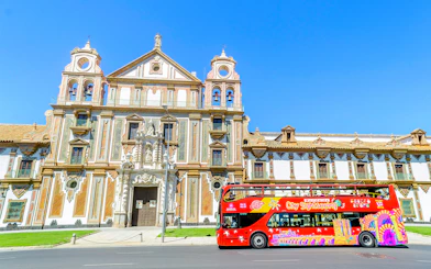 City sightseeing bus in front of historic building in Córdoba.
