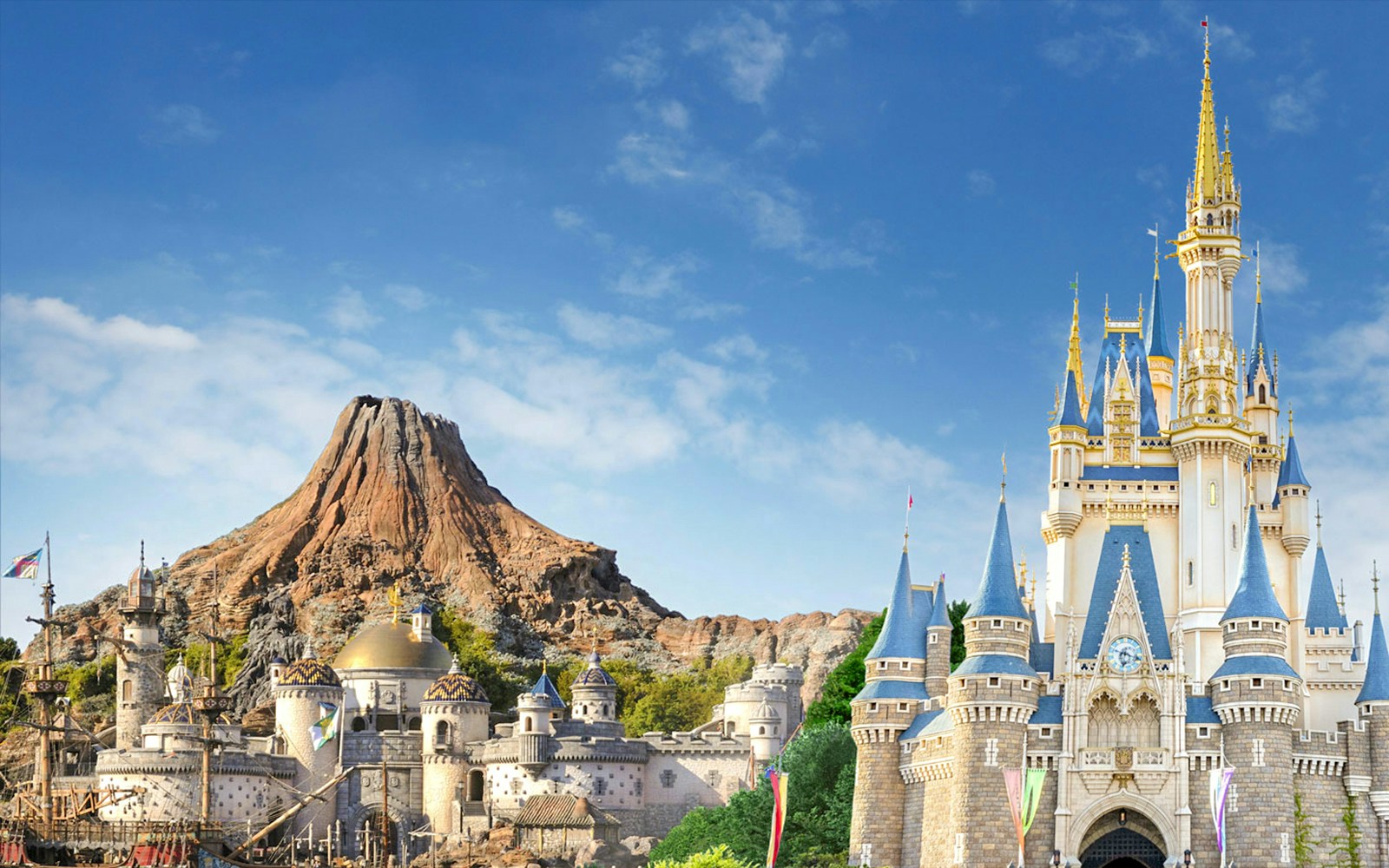 Tokyo DisneySea's Mount Prometheus and Cinderella Castle under a clear blue sky.