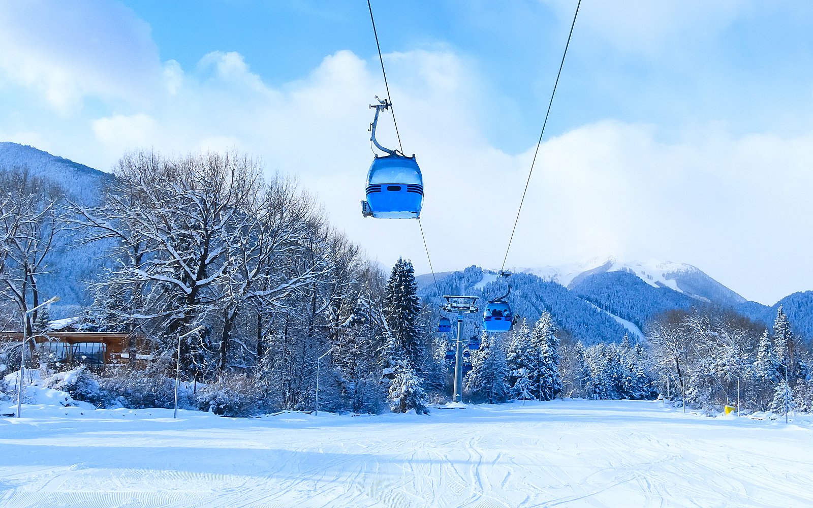 Ski lift ascending snowy mountain at Sanlaiva Ski Resort.