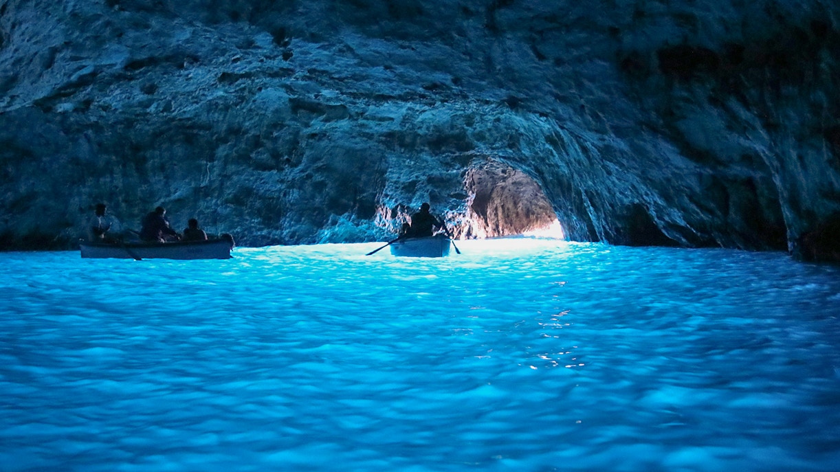 Tourists on boat inside Blue Grotto