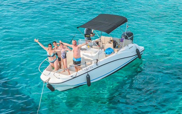 People on a private speedboat approaching Tiran Island, Sharm El Sheikh, with clear blue waters.