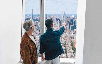Visitors enjoying the New York City skyline from One World Observatory.